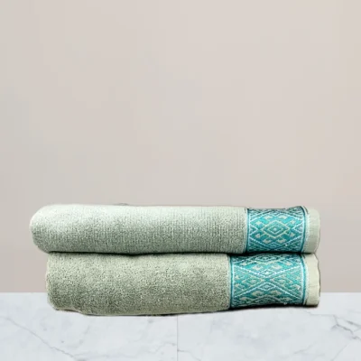 a stack of towels on a marble surface green towel 600 gsm towel
